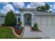 Inviting home entrance features a covered porch and landscaped yard with beautiful stone and mulch accents at 5195 Nw 21St Loop, Ocala, FL 34482