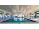 Spacious indoor pool with natural light and ample seating for a comfortable swimming experience at 5195 Nw 21St Loop, Ocala, FL 34482