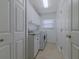 Well-organized laundry room with white cabinets, granite countertops, and modern washer and dryer units at 5195 Nw 21St Loop, Ocala, FL 34482