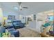Comfortable living area featuring tile floors, natural light from the skylight, and blue sofas at 5195 Nw 21St Loop, Ocala, FL 34482