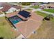Home featuring a large screened-in pool area and energy-efficient solar panels at 5770 Sw 89Th Pl, Ocala, FL 34476