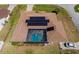 An aerial view of a home with a screened-in pool and solar panels at 5770 Sw 89Th Pl, Ocala, FL 34476
