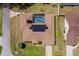 An aerial view of a house with a screened-in pool and solar panels at 5770 Sw 89Th Pl, Ocala, FL 34476