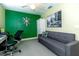 Office with a modern desk, gray carpet, a ceiling fan, and a decorative green wall at 5770 Sw 89Th Pl, Ocala, FL 34476