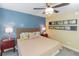 Inviting bedroom with a ceiling fan, soft lighting, comfortable bed, and two side tables with lamps at 5770 Sw 89Th Pl, Ocala, FL 34476