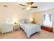 Comfortable bedroom with ceiling fan and bright natural light at 5770 Sw 89Th Pl, Ocala, FL 34476
