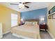 Inviting bedroom with a ceiling fan, soft lighting, comfortable bed, and two side tables with lamps at 5770 Sw 89Th Pl, Ocala, FL 34476