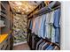 This walk-in closet boasts bold floral wallpaper, custom shelving, and ample storage space for clothing and accessories at 5770 Sw 89Th Pl, Ocala, FL 34476