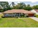 Charming home exterior showcasing lush landscaping and a welcoming entrance at 5770 Sw 89Th Pl, Ocala, FL 34476