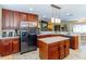 Open kitchen showcasing stainless steel appliances, granite countertops, and wooden cabinetry at 5770 Sw 89Th Pl, Ocala, FL 34476