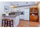 This kitchen features bright white cabinets, bar seating, and modern appliances at 5770 Sw 89Th Pl, Ocala, FL 34476