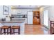 This kitchen features bright white cabinets, bar seating, and modern appliances at 5770 Sw 89Th Pl, Ocala, FL 34476
