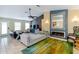 Open-concept living room with a fireplace, modern furnishings, and abundant natural light at 5770 Sw 89Th Pl, Ocala, FL 34476