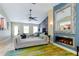 Spacious living room with modern fireplace, stylish decor, and comfortable seating arrangement at 5770 Sw 89Th Pl, Ocala, FL 34476