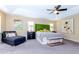 Comfortable main bedroom featuring a chaise lounge, ceiling fan, and closet at 5770 Sw 89Th Pl, Ocala, FL 34476