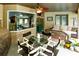 Relaxing patio with dining table, seating area, pass-through window, and ceiling fan at 5770 Sw 89Th Pl, Ocala, FL 34476