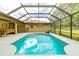 Inviting outdoor pool area with screened enclosure at 5770 Sw 89Th Pl, Ocala, FL 34476