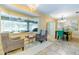 Bright sitting area with a large bay window overlooking the pool and an adjacent dining area at 5770 Sw 89Th Pl, Ocala, FL 34476