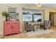 Cozy sitting area with comfortable chairs and charming decor, illuminated by a stylish chandelier at 5770 Sw 89Th Pl, Ocala, FL 34476