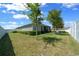 Large backyard with a well-manicured lawn and a white fence at 6437 Sw 45Th Ave, Ocala, FL 34474