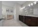 Bright bathroom features a double vanity with granite countertops, tile floors, and natural light at 6437 Sw 45Th Ave, Ocala, FL 34474