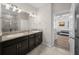 Bathroom with granite vanity, dual sinks, tiled floors, and walk-in shower at 6437 Sw 45Th Ave, Ocala, FL 34474