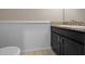 Half bathroom with a granite countertop and white wainscoting at 6437 Sw 45Th Ave, Ocala, FL 34474