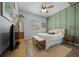 Bedroom with plank flooring, green accent wall, and natural light at 6437 Sw 45Th Ave, Ocala, FL 34474