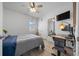 Bedroom features a ceiling fan, closet, and workstation at 6437 Sw 45Th Ave, Ocala, FL 34474