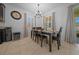 Bright dining room features a classic table set, large windows, and modern chandelier at 6437 Sw 45Th Ave, Ocala, FL 34474