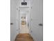 Hallway view showcasing tile floors, wall decor, and interior doors at 6437 Sw 45Th Ave, Ocala, FL 34474