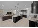 Bright, open kitchen with an island, dark cabinets, and stainless-steel appliances adjoining a cozy living area at 6437 Sw 45Th Ave, Ocala, FL 34474