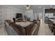 Open-concept living room with a leather sectional, neutral decor, and view into the kitchen at 6437 Sw 45Th Ave, Ocala, FL 34474