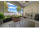 Screened patio with ceiling fan, comfortable seating, and manicured backyard view at 6437 Sw 45Th Ave, Ocala, FL 34474