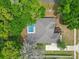 Overhead view of a home featuring a screened-in pool, surrounded by mature trees and a lush landscape at 802 Se 50Th Ter, Ocala, FL 34471