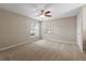 Bedroom showcasing neutral walls, carpet, a ceiling fan, and two windows at 802 Se 50Th Ter, Ocala, FL 34471