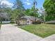 Charming single-story home with a well-maintained lawn, mature trees, and long driveway at 802 Se 50Th Ter, Ocala, FL 34471
