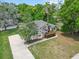 Charming single-story home with lush landscaping and an expansive driveway at 802 Se 50Th Ter, Ocala, FL 34471