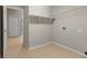 Functional laundry room equipped with shelving and tiled floors, located near the entrance at 802 Se 50Th Ter, Ocala, FL 34471