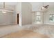 Spacious living room featuring high ceilings and carpet flooring with a view of the pool at 802 Se 50Th Ter, Ocala, FL 34471