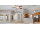 Open concept living space featuring a vaulted ceiling, ceiling fan and view of the kitchen bar seating at 802 Se 50Th Ter, Ocala, FL 34471