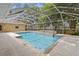 Beautiful in-ground pool with a screen enclosure and patio area at 802 Se 50Th Ter, Ocala, FL 34471