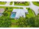 Aerial view featuring a home with screened pool, lush landscaping, and fenced backyard at 828 Ne 51St Ave, Ocala, FL 34470