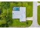 Aerial view of a home with a screened pool, landscaped yard, and well-maintained roof at 828 Ne 51St Ave, Ocala, FL 34470
