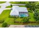 Home featuring a screened-in pool, mature landscaping, fenced backyard, and a well-kept lawn at 828 Ne 51St Ave, Ocala, FL 34470