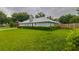 Backyard of a home with a green lawn, a fence, and mature trees that offer lots of privacy at 828 Ne 51St Ave, Ocala, FL 34470