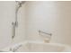 Bathtub in updated bathroom with grab bars and shower head at 828 Ne 51St Ave, Ocala, FL 34470
