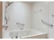 White tub and tile bathroom with grab bars at 828 Ne 51St Ave, Ocala, FL 34470