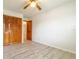 View of bedroom with gray wood-look floors, closet, white walls and window at 828 Ne 51St Ave, Ocala, FL 34470