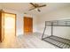 Bedroom featuring bunkbeds, a closet with bi-fold doors, and a full size door at 828 Ne 51St Ave, Ocala, FL 34470
